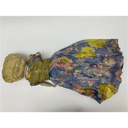 Victorian large wax over composition Pumpkin head doll, with inset dark glass eyes, moulded blonde hair in curls, stuffed body with carved and painted wooden limbs, grey painted boots, floral satin dress with netting underclothes H61cm
