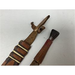 Indian kukri with 29cm curving steel blade and nickel mounted horn grip; in leather covered scabbard with one skinning knife L42cm overall; Hitler Youth knife with scabbard in relic condition; and three African graduated knives each with crudely carved wooden grips and painted leather covered scabbards (5)