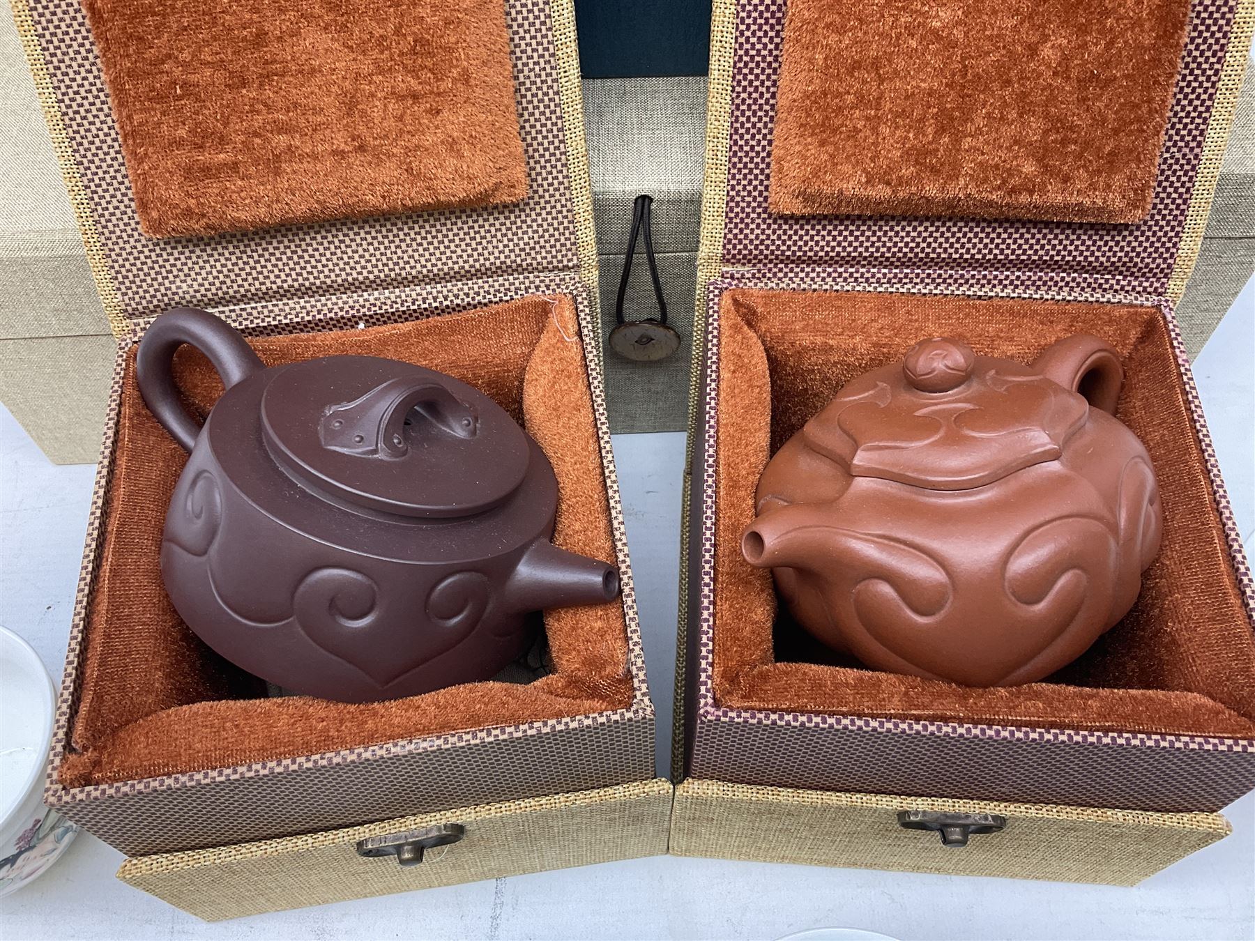 Two Chinese Yixing teapots, Chinese tea bowl hand painted with figures reading, another tea bowl with with underglaze floral panel and another tea bowl with saucer and lid, together with other teacups etc all boxed and with character marks