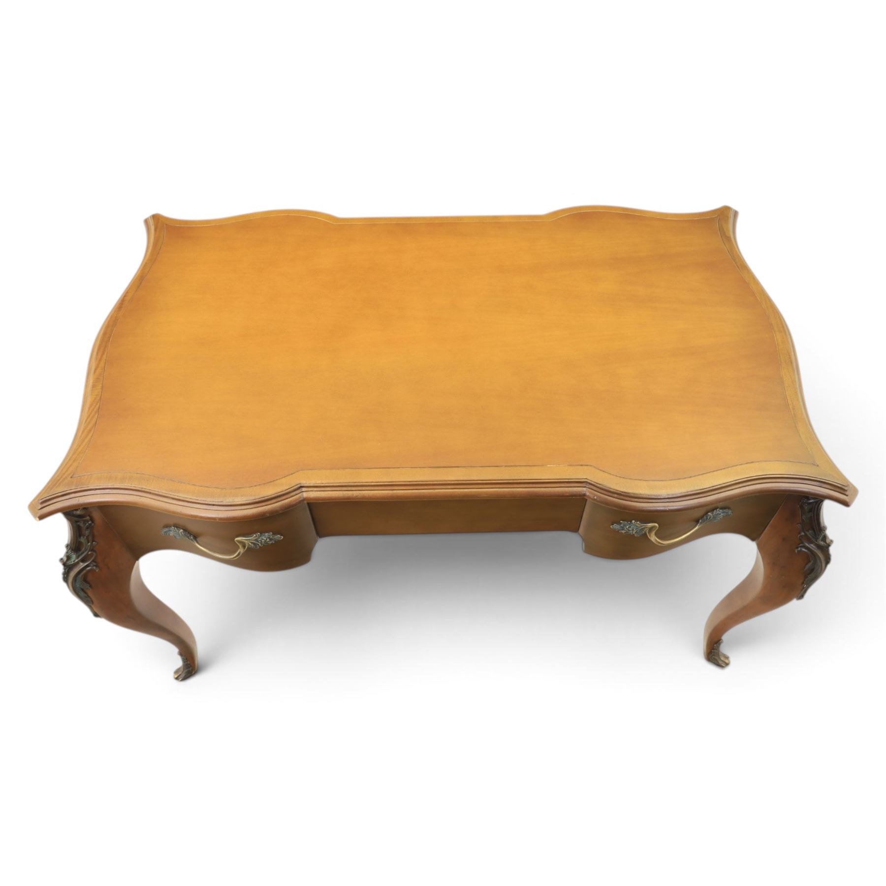 And So To Bed - Cherrywood serpentine dressing table, two drawers with brass handles foliate design with applied gilt mounts, raised on cabriole legs with gilt caps