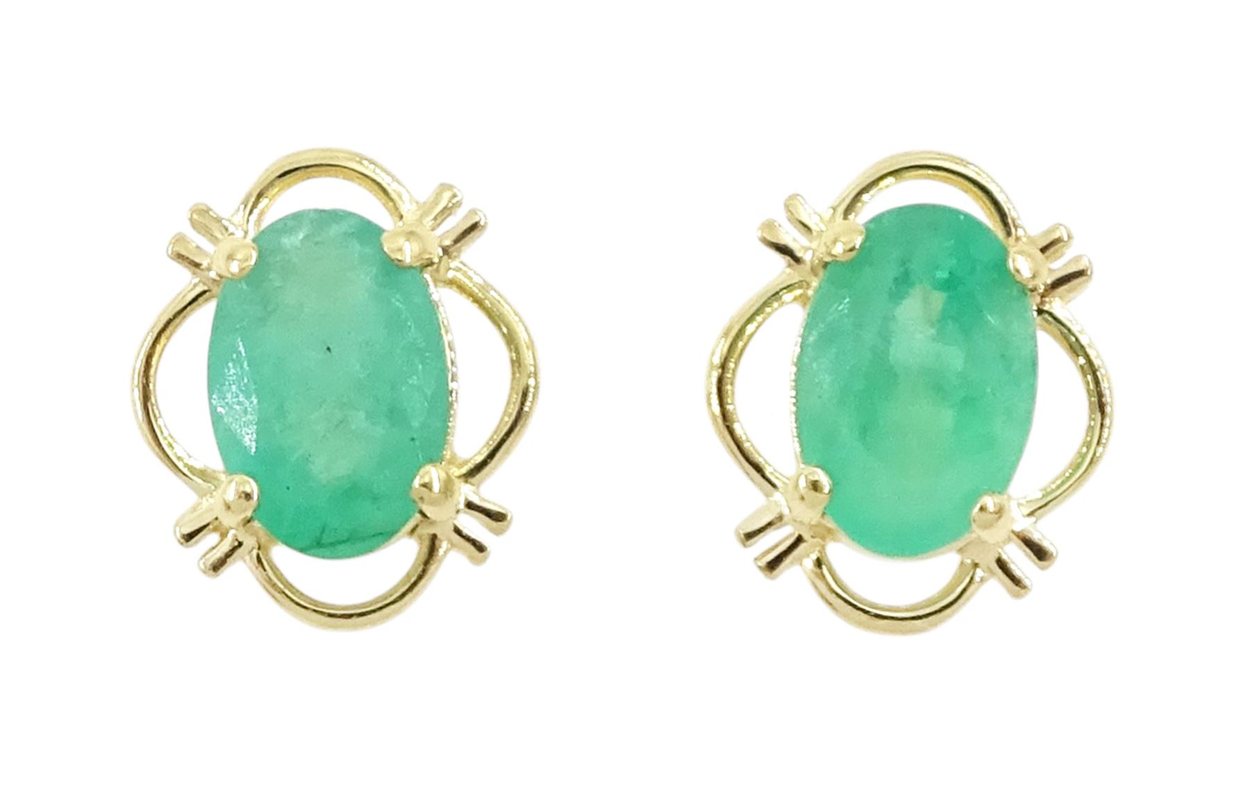 Pair of 9ct gold oval cut emerald stud earrings, stamped