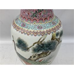 Group of modern Oriental ceramics, to include, Chinese floral vase with peacock decoration, and black script to pink neck, ginger jar with lid featuring figures walking under trees, large bowl with floral and bird decoration and another vase, all upon oriental carved wooden stands, tallest example H51cm