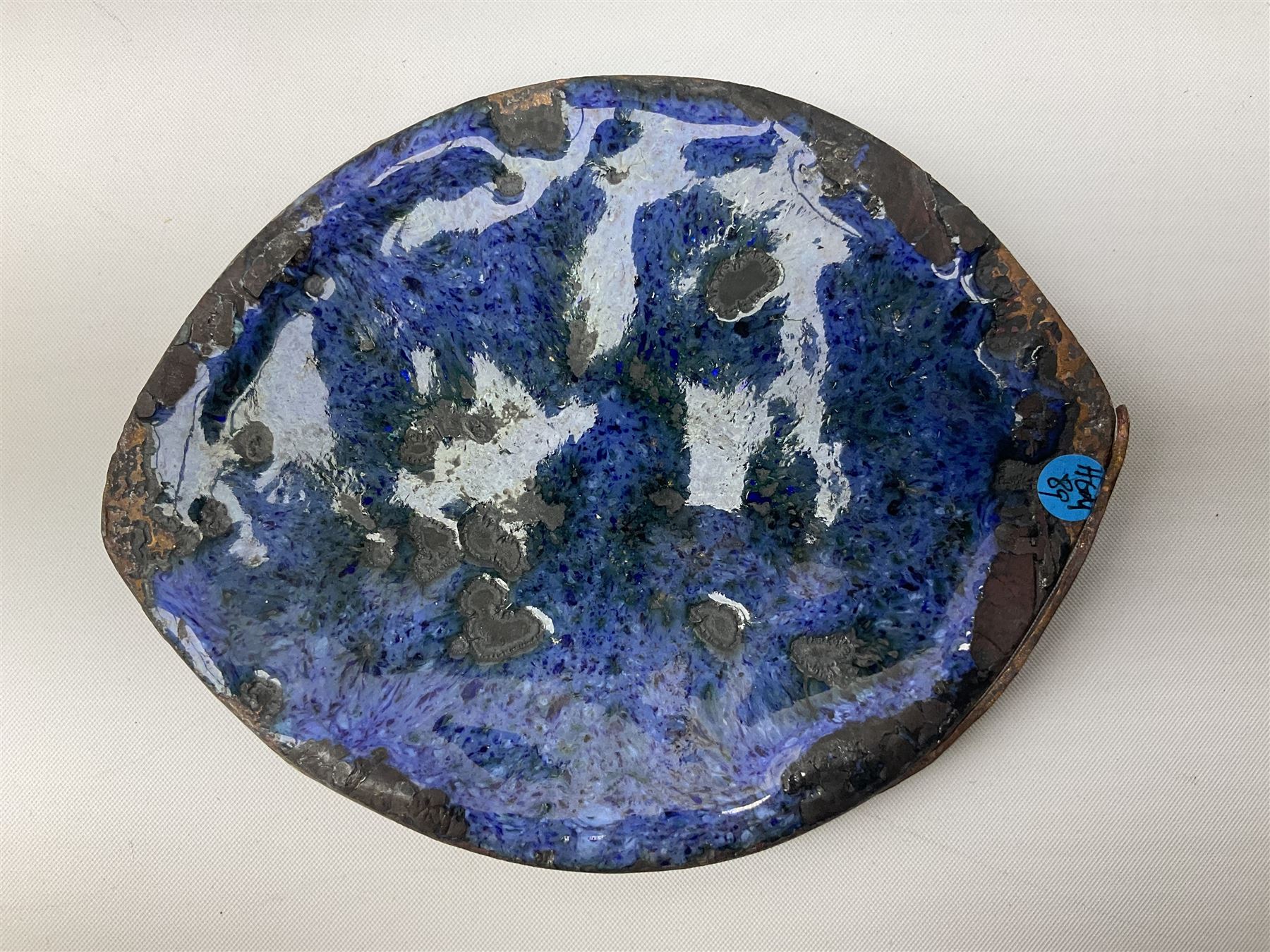 Henry George Murphy (1884-1939), Arts & Crafts enamel panel, of bulbous elliptical form decorated with a stylised crown in green, red and white, upon a turquoise toned ground, H12cm W9cm