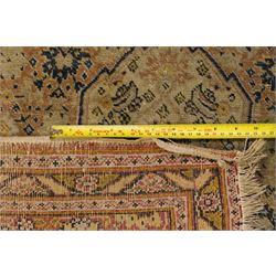 Two hand-knotted rugs, comprising Persian medallion rug and tribal rug, Persian hand-knotted rug, ivory ground centred by shaped floral medallion with pendants, surrounded by stylised flowerheads and foliate motifs, enclosed by multiple floral and geometric borders, H155cm, W123cm; tribal hand-knotted rug, dark brown ground with repeating linked geometric diamond medallions in orange and green, enclosed by ivory geometric border, striped ends with fringes, H150cm, W71cm