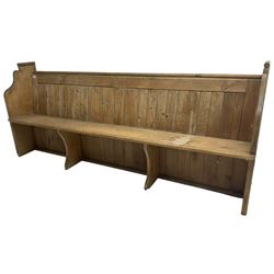 Early 20th century pine church pew, vertical plank back over rectangular seat, flanked by shaped end supports, with bible rest to back