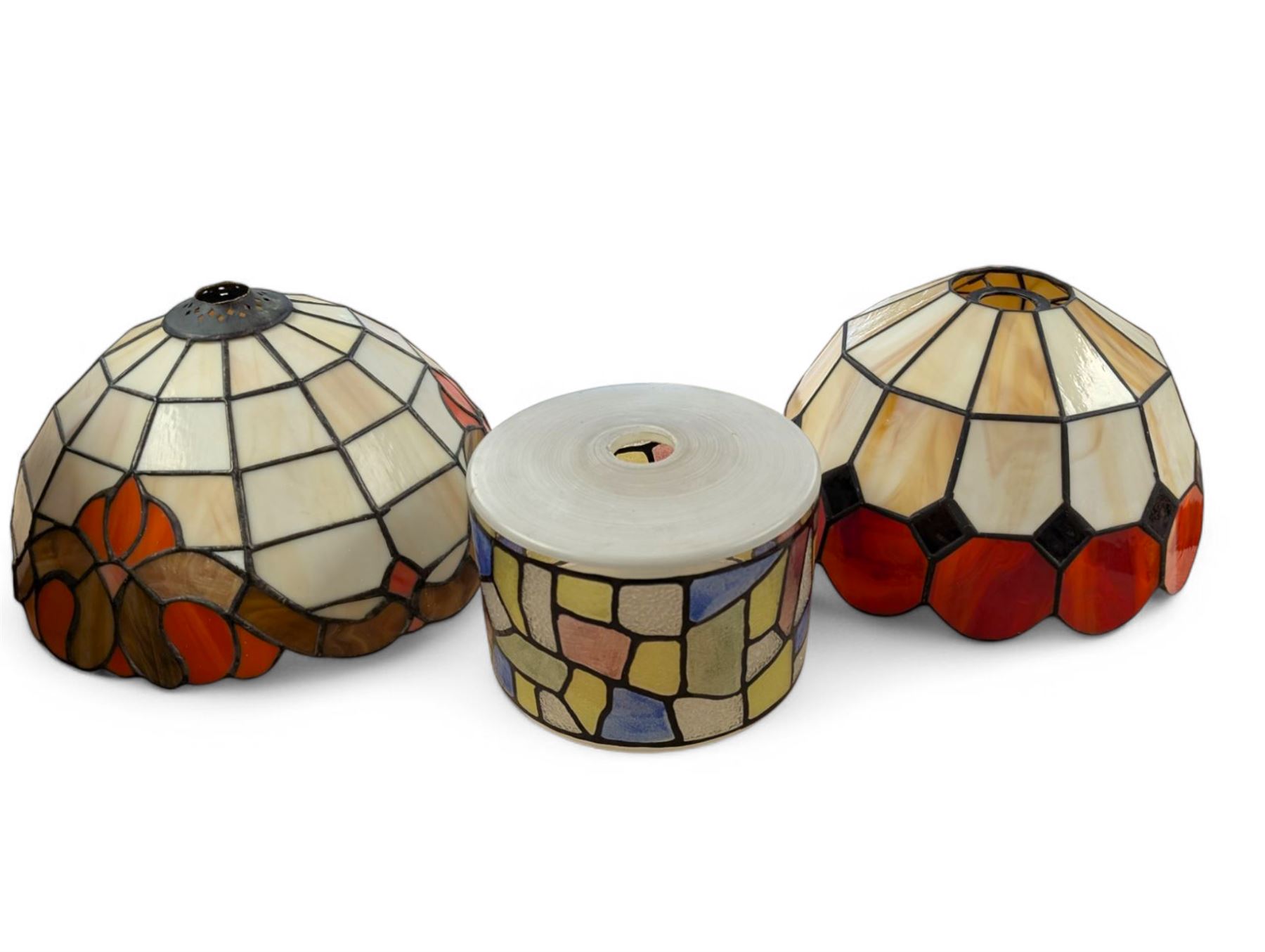 Two Tiffany style domed lampshades, together with a circular glass shade with stained glass decoration, largest H15cm, D30cm