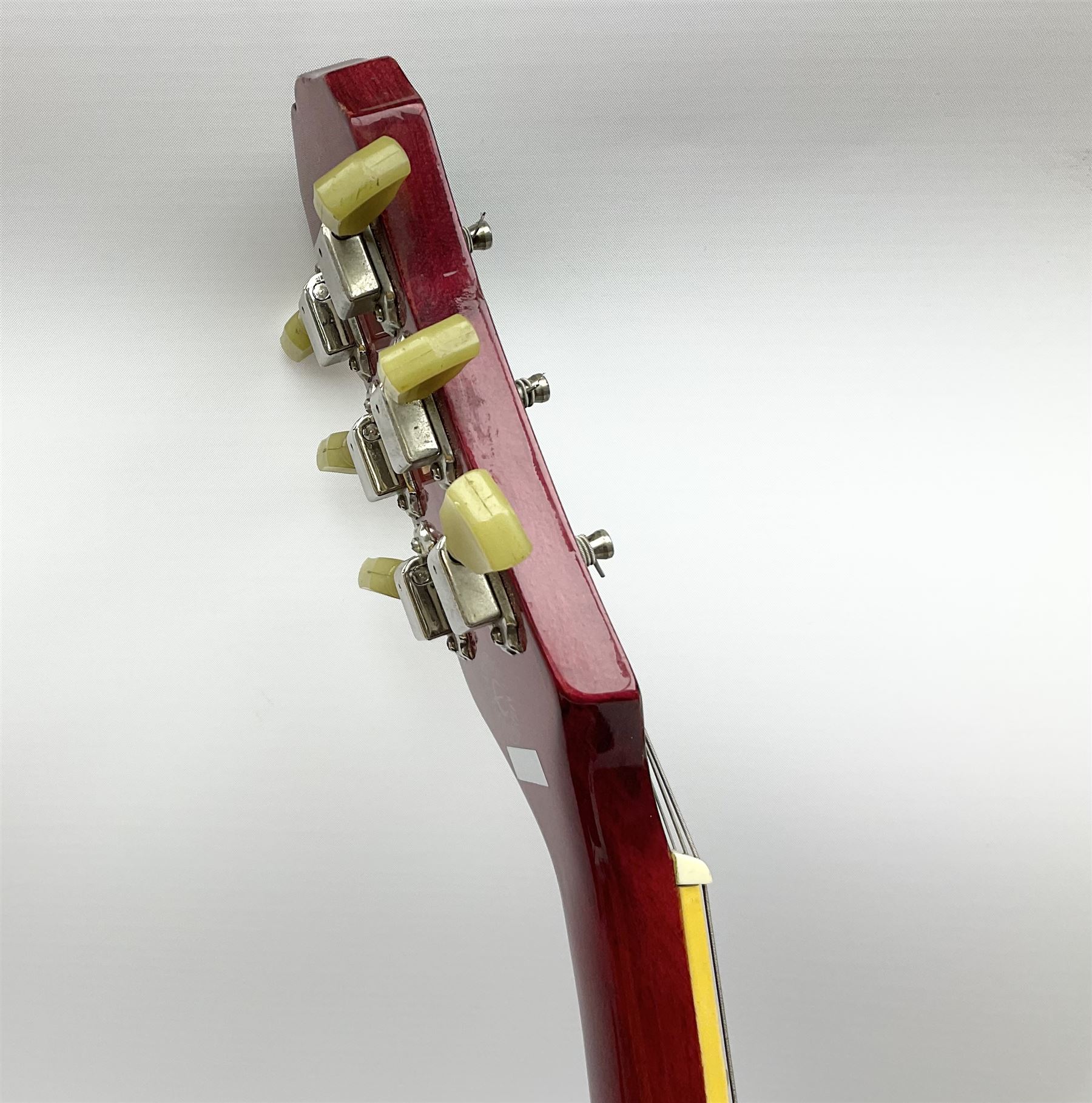 1980s Les Paul Epiphone limited edition cut-away electric guitar by Gibson, the burgundy coloured body with two pick-ups, volume and tone knobs and scratch plate, original tuning pegs, serial no.U6030215, 101cm overall; in modern Kinsman fitted carrying case