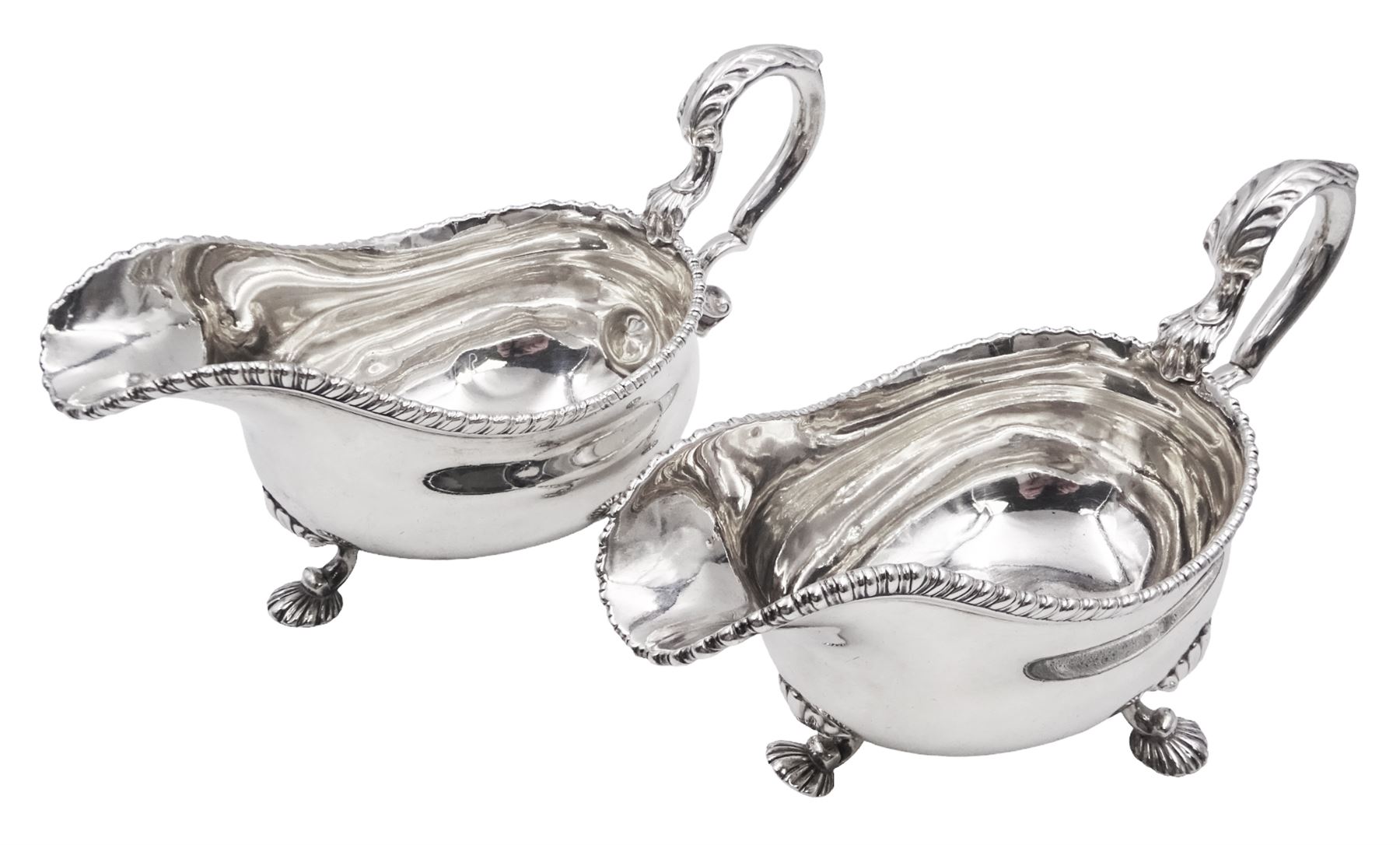 Pair of George III silver sauce boats, each of typical form with gadrooned rim, and acanthus capped scroll handle, upon three shell mounted shell pad feet, hallmarked George Methuen, London 1760 including handle H13cm, approximate total weight 30.25 ozt (941 grams)