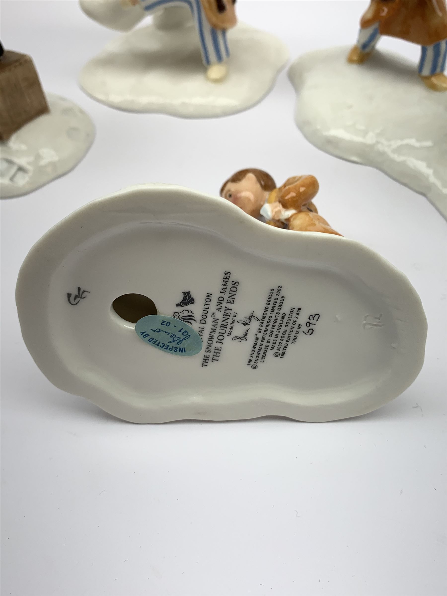 Four limited edition Royal Doulton The Snowman figures, comprising The Snowman and James dancing in the snow, 390/2,500, The Snowman and James Dressing the Snowman, 518/2,500, The Snowman and James The Adventure Begins, 1062/2,500, and The Snowman and James The Journey Ends, 693/2,500, each with accompanying certificate. 