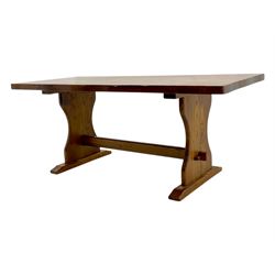 Late 20th century oak trestle table, rectangular top with naturalistic edge, supported by two curved pedestal bases united by central stretcher, on block feet