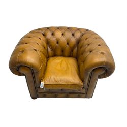 Chesterfield armchair, upholstered in buttoned tan leather with studded detail, on turned feet