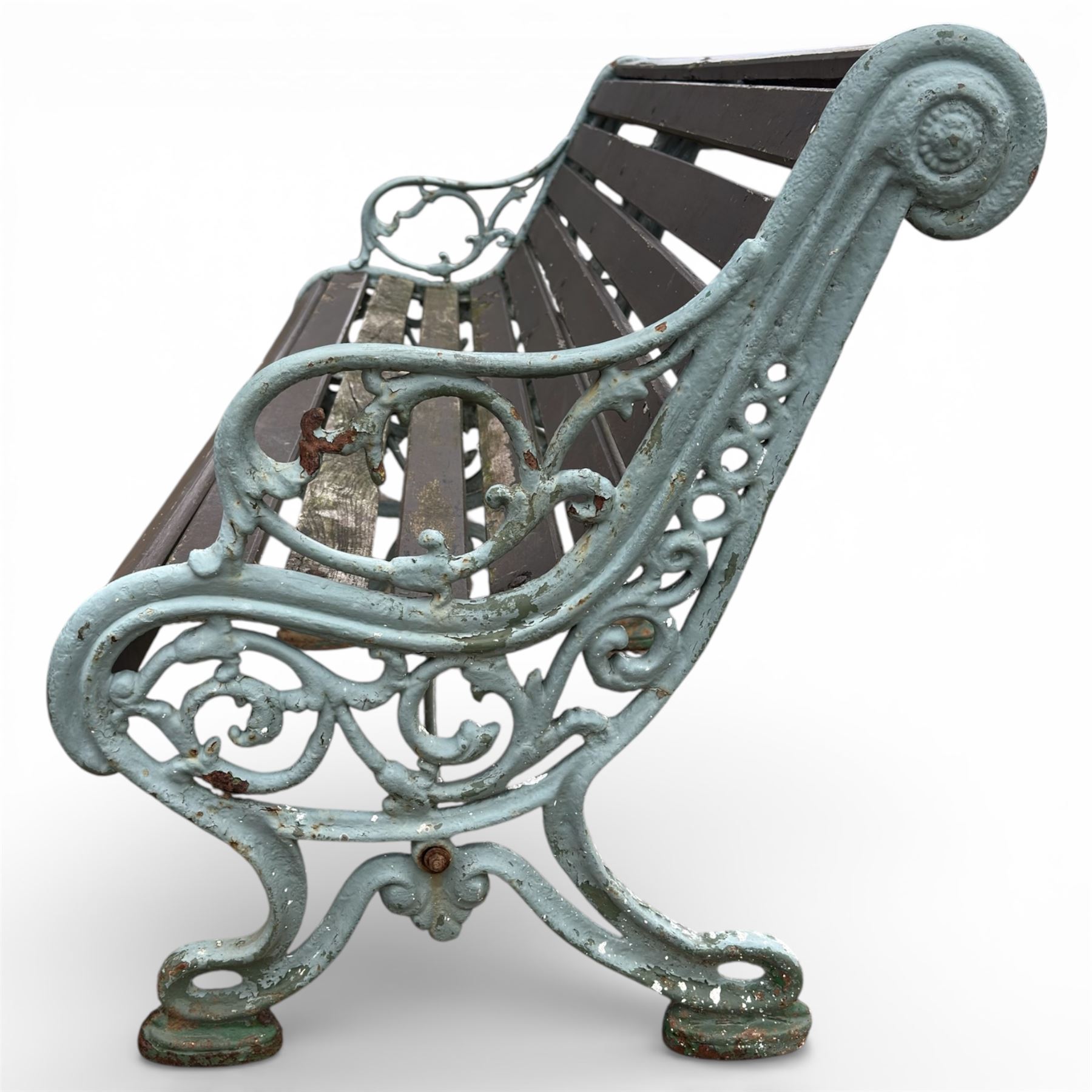 Victorian cast iron garden bench with dark wooden slats and ornate green painted ends.