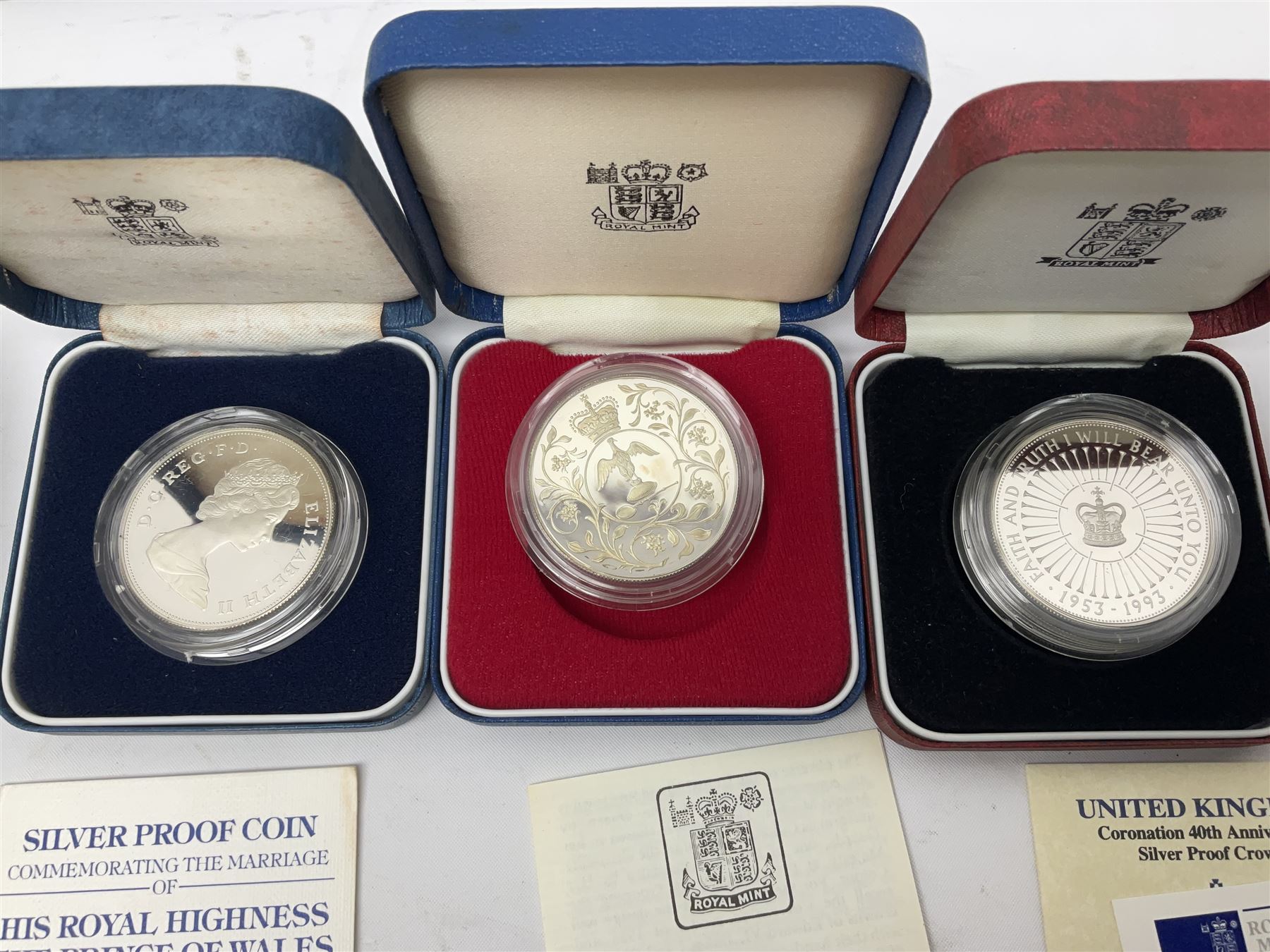 Seven The Royal Mint United Kingdom sterling silver proof crown coins, comprising two 1972, three 1977, 1981 and 1993, all cased with certificates and a Queen Elizabeth II 2001 one ounce fine silver Britannia coin on card (8)