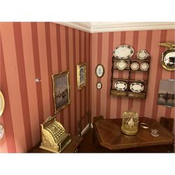 Good quality late 20th century dolls house by M. James dated 1995 in the form of a Beverley East Yorkshire Antique Shop called 'North Bar Antiques'; single-storey single-roomed shop with textured brick walls and flat roof, fully glazed hinged front with recessed hinged customer door and central window to the rear; comprehensively furnished with chests of drawers, pedestal desk, breakfast table, lowboy, two longcase clocks, delft rack with ceramics, occasional tables, pictures, Regency style mirror and collectibles; decorated walls with coving and picture rail and simulated floorboarding; wired for electric lighting; maker's plaque W61cm H42.5cm D41.5cm