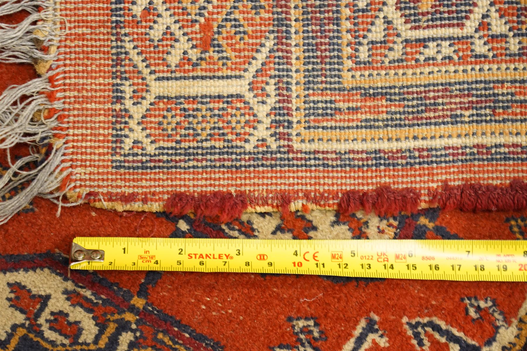 Two hand-knotted rugs, comprising Turkoman Ersari rug and Bokhara rug, Turkoman Ersari hand-knotted rug, terracotta ground with two rows of repeating octagonal guls interspersed with geometric motifs, enclosed by multiple geometric borders, fringed ends, H125cm, W93cm; Bokhara hand-knotted rug, madder red ground with three rows of repeating Tekke guls interspersed with geometric motifs, enclosed by multiple stylised floral and geometric borders, fringed ends, H188cm, W126cm