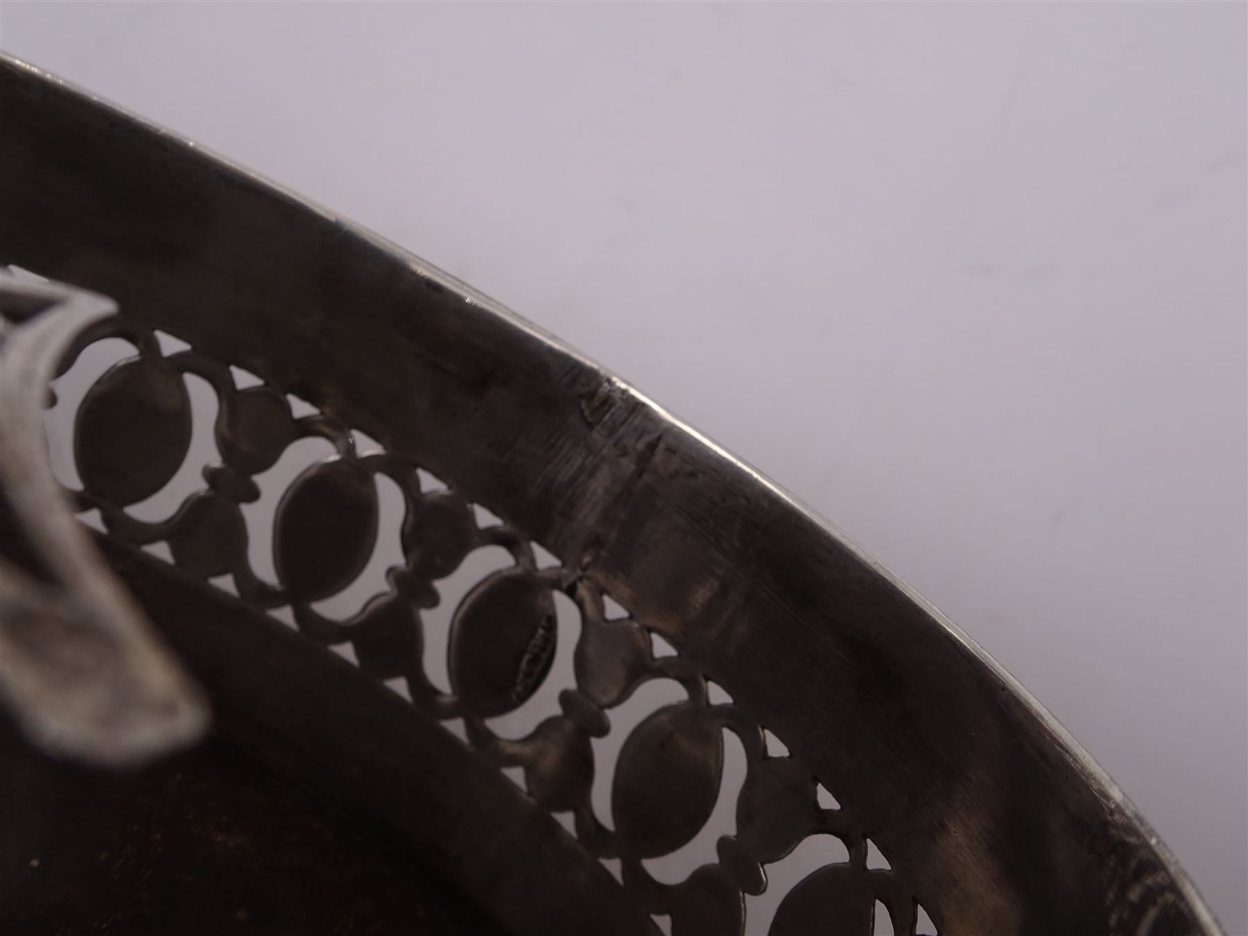 Late 18th century silver cruet stand, of oval form, with pierced sides upon four bun feet, hallmarked to handle Hester Bateman, all other hallmarks indistinct, together with five matched silver mounted cut glass cruet bottles, including some later Victorian examples, hallmarks predominantly indistinct, stand H20cm