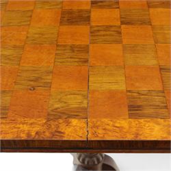 Early 20th century walnut chess table, square checkered veneered top with crossbanded edge, raise on a turned column based with acanthus craving, on three outswept legs terminating in brass paw caps above castors
