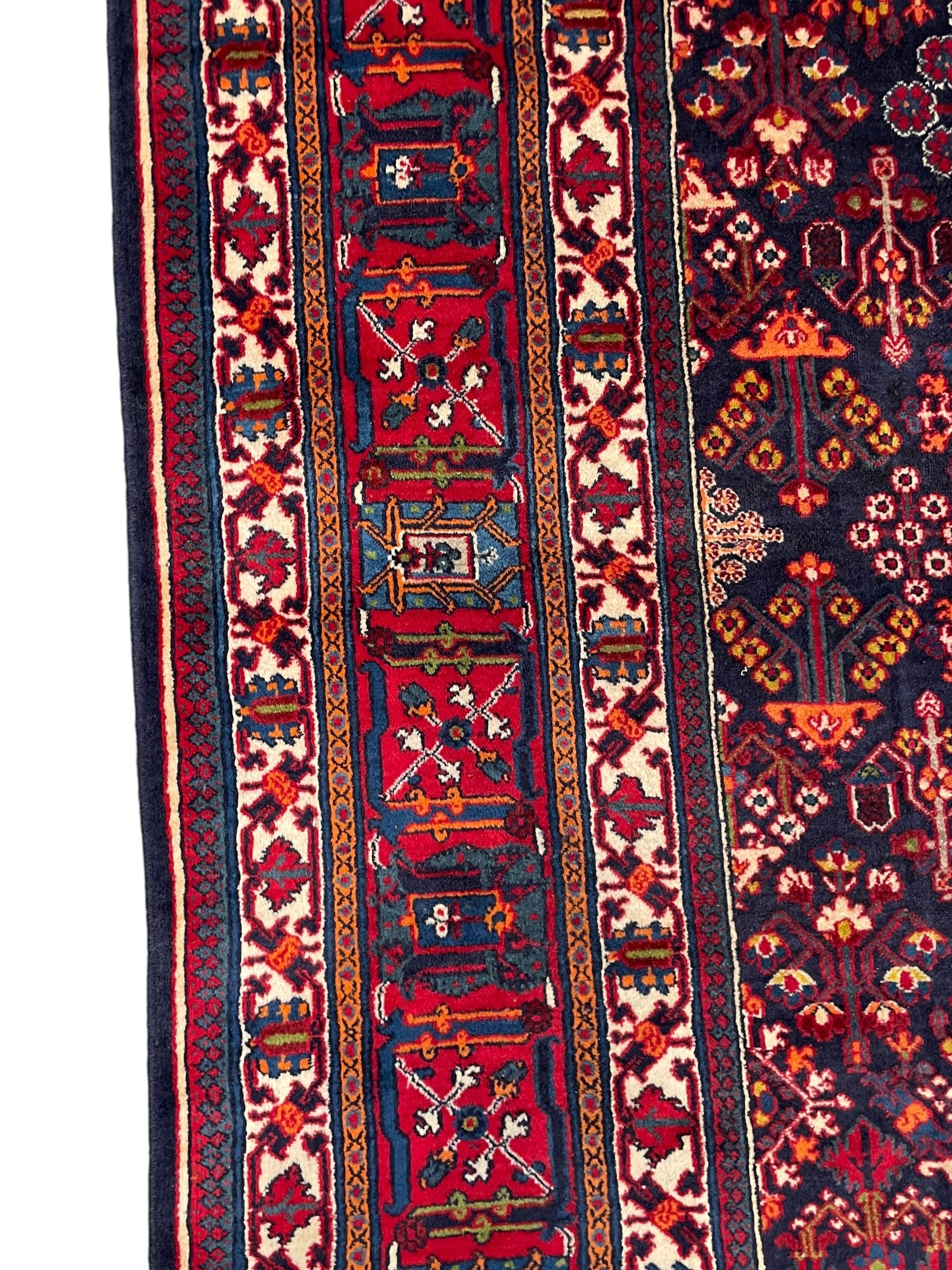 Persian Meimeh indigo ground rug, the central medallion within a field of small floral lozenge motifs, the guarded border with repeating pattern