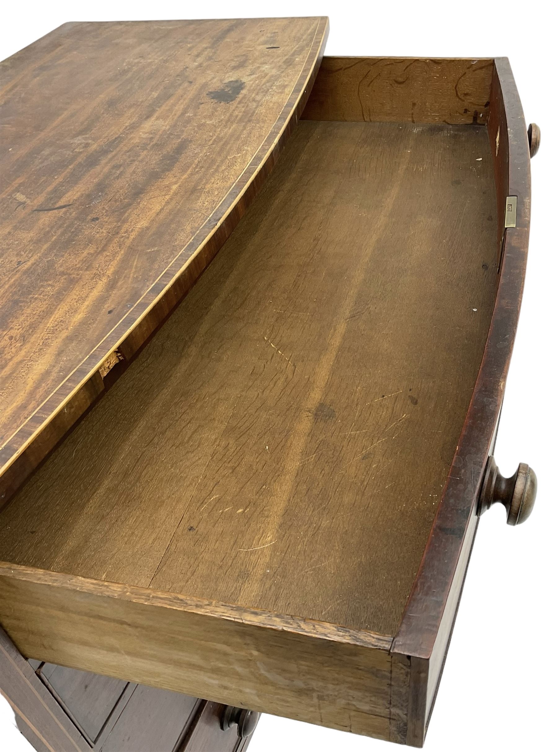 George III mahogany bow-front chest, crossbanded top with satinwood stringing, fitted with four graduating cock-beaded drawers, each with bone shield shaped escutcheons and turned handles, shaped apron flanked by splayed feet