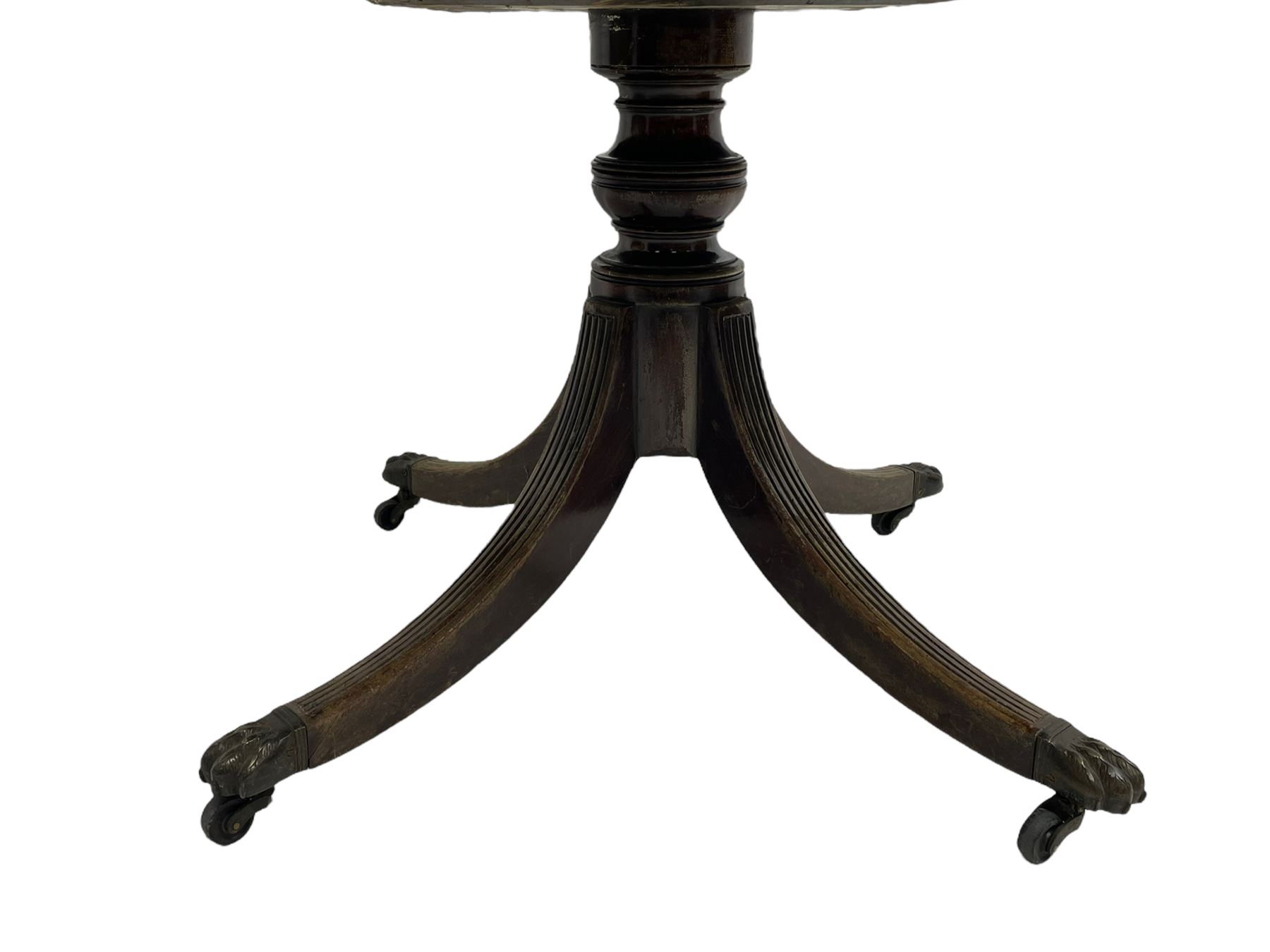 George III mahogany breakfast table, the oval top with a kingwood band and boxwood stringing, raised on a turned vasiform pedestal terminating in a fluted sabre tripod base with hairy paw feet and castors