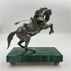 Modern silver model of a rearing horse, with ornate parcel gilt saddle and bridle, mounted upon a rectangular base, decorated with malachite panels to each side and upon four gilt bun feet, horse stamped 925, overall H14.5cm