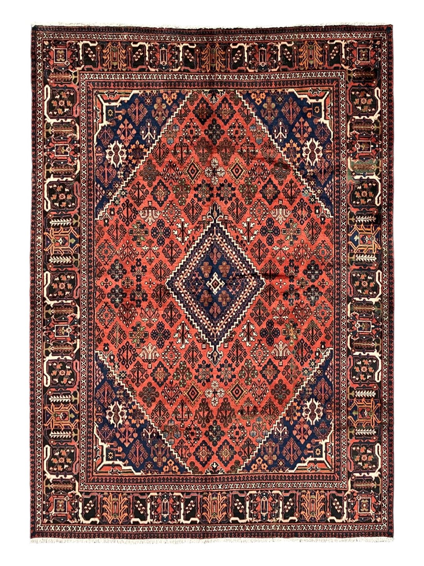 Persian Joshgan red ground rug, the medallion, field and spandrels decorated with clusters of Pitrak and tree of life motifs, the border with repeating design decorated with stylised plant motifs, within guard stripes