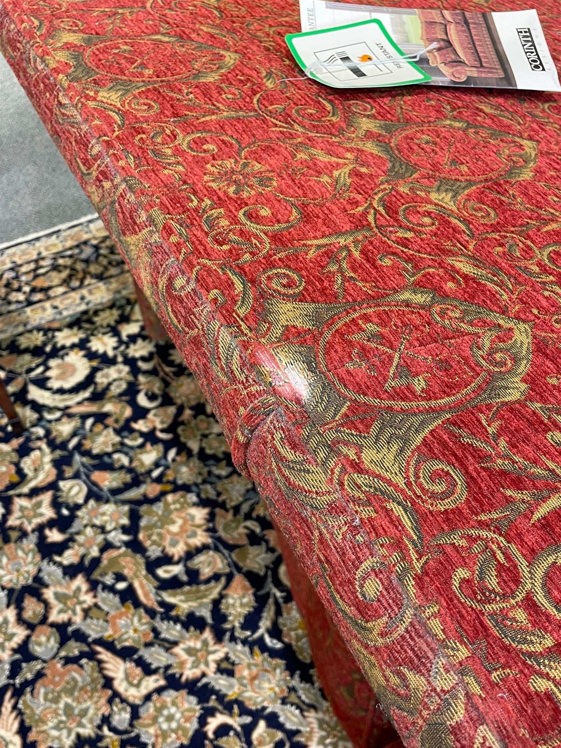 Large Knole design hardwood-framed three-seat drop-arm sofa, upholstered in crimson fabric decorated with trailing acanthus leaves and shields, together with scatter cushions 