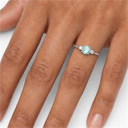 18ct white gold Paraiba tourmaline and diamond three stone ring, single round cut tourmaline of approx 1.50 carat, with a single round brilliant cut diamond set either side, hallmarked, total diamond weight approx 0.15 carat