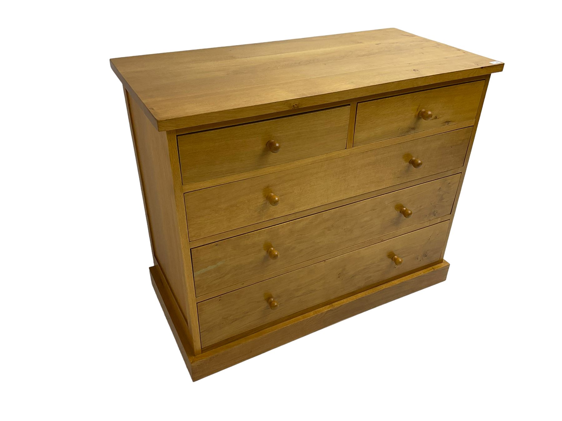 Craftsman made light oak chest, fitted with two short and three long drawers, on plinth base