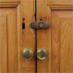 19th century waxed pine press cupboard, shaped cornice above a twin fielded panelled cupboard door enclosing a fixed shelf, the lower section two short two long drawer