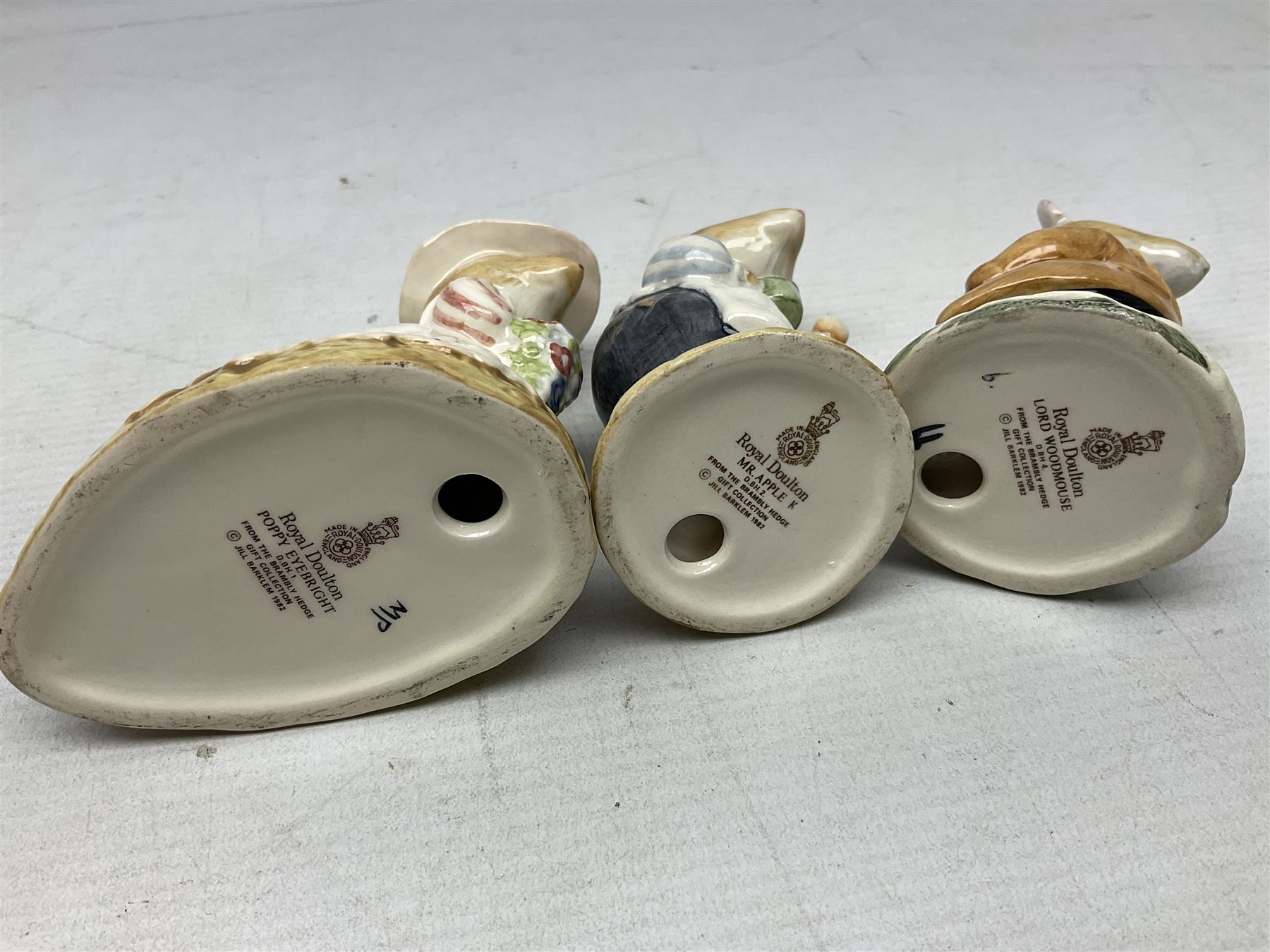 Six Royal Doulton Brambly Hedge figures, comprising Catkin DBH 12, Clover DBH 16, Lord Woodmouse DBH 4, Poppy Eyebright DBH 1, Mr Apple DBH 2, Old Mrs Eyebright DBH 9 and Beswick Beatrix Potter Appley Dapply figure, all with printed marks beneath