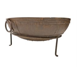 Circular riveted iron fire pit, strapwork sides with twin handles on stand, with grate
