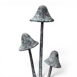 Bronze garden ornament in the form of three mushroom stalks, on naturalistic base