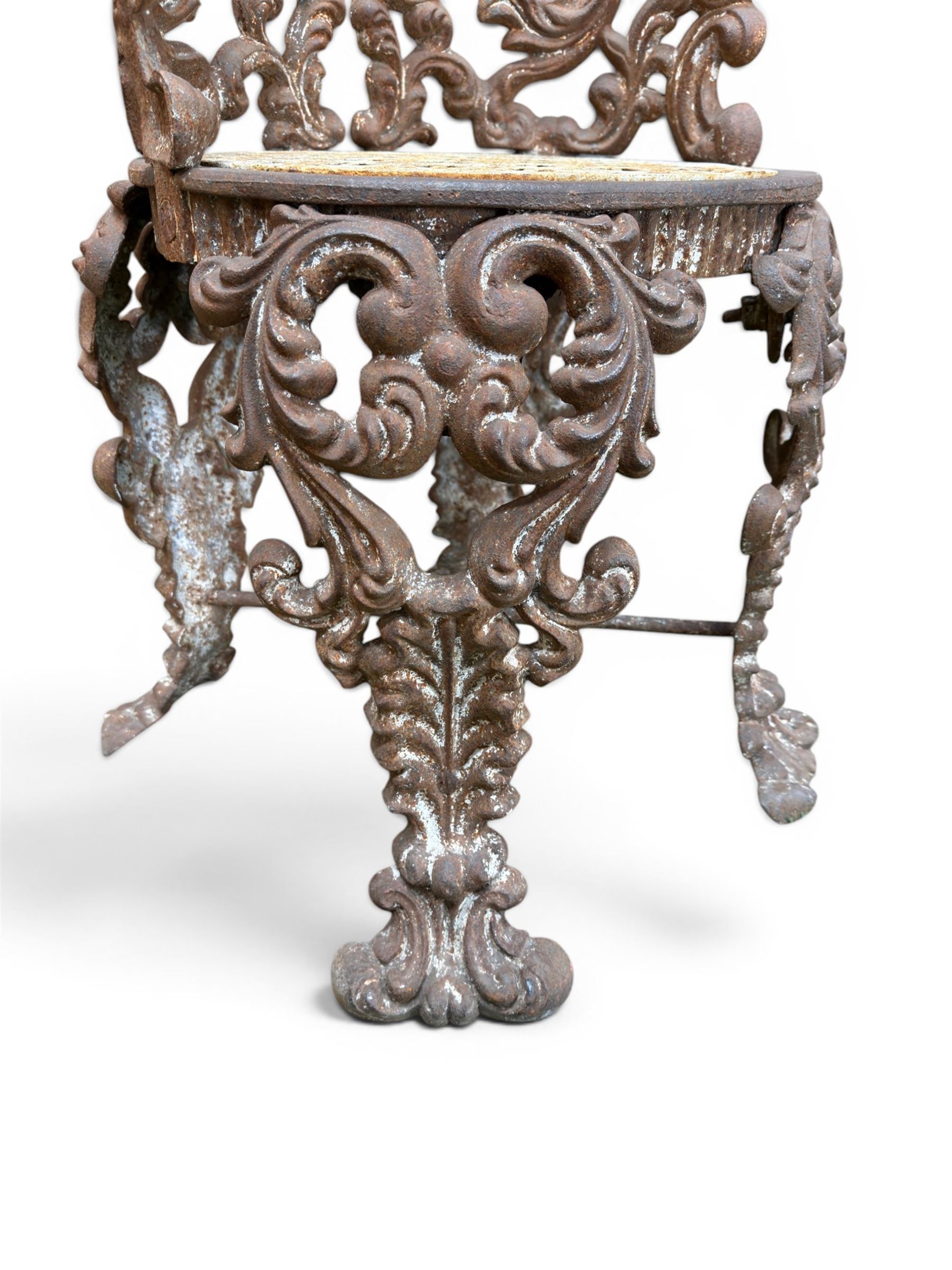 19th century Rococo Revival cast iron garden chair, pierced back comprised of scrolling acanthus leaves, over a pierced geometric white painted drop-in seat, raised on four acanthus and anthemion shaped cabriole supports united by X-frame stretcher