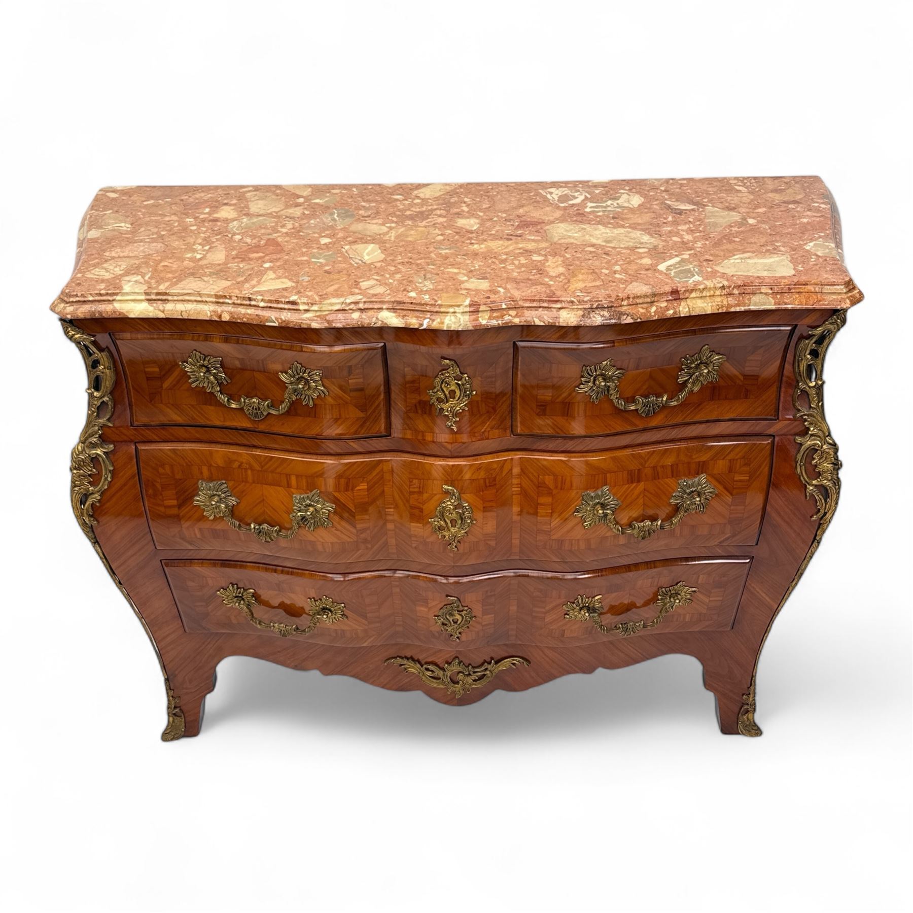 20th century Louis XV design serpentine commode, the rectangular breccia marble top with a rounded moulded edge and projecting corners, above a bombe bombe-shaped kingwood and parquetry design front of two short and two graduated drawers with rococo style handles, corners with gilt-bronze foliate mounts on short cabriole form feet with gilt bronze sabots  