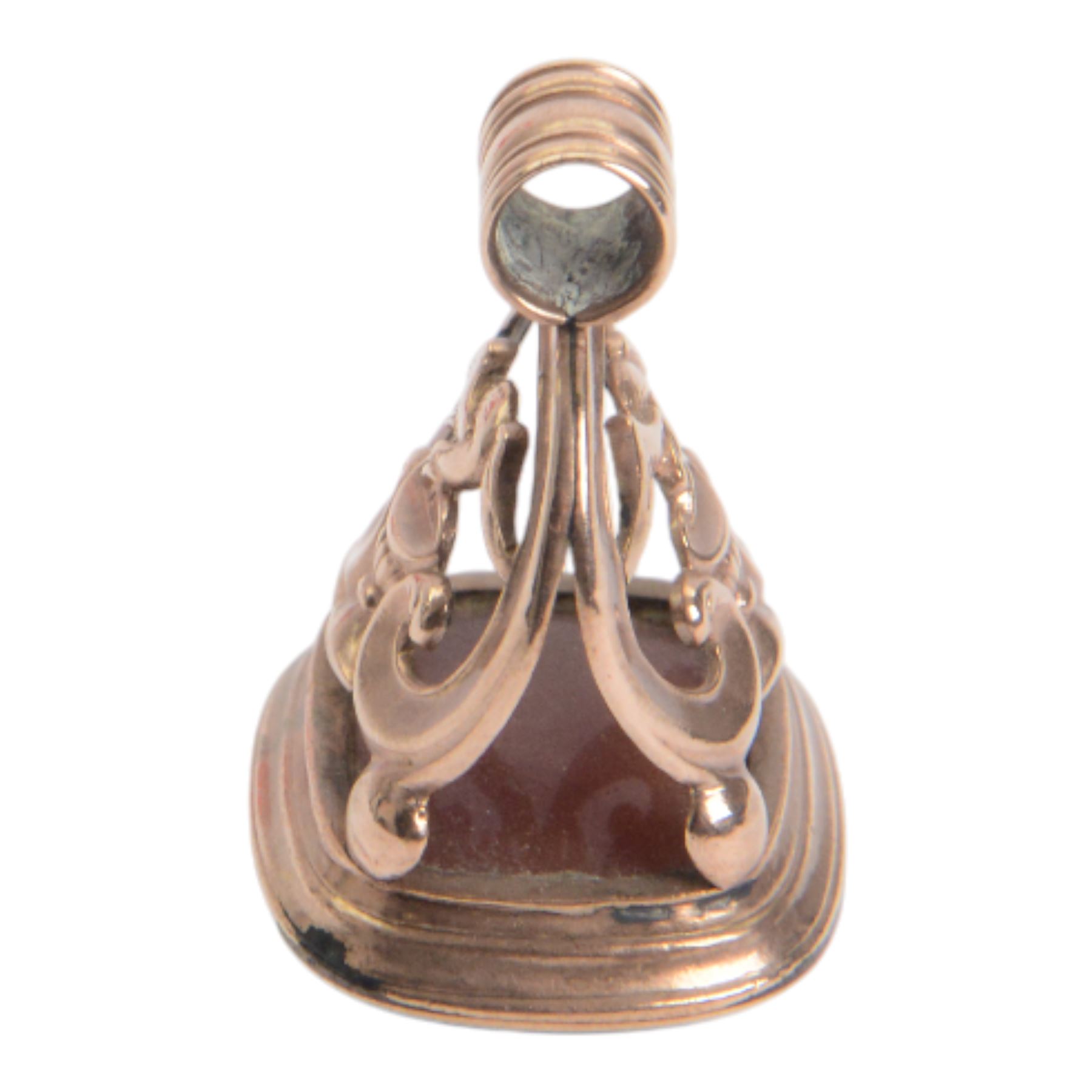 Late 18th/early 19th century 9ct gold fob seal, the carnelian matrix engraved with coat of arms, depicting a shield surmounted by a bird with foliage within its beak, within a scrolling mount detailed with a bird drinking from a chalice, H3.5cm 

Provenance: By family descent from the Chichesters of Arlington Court, Devon; from the collection of Andrew Chichester Everitt.