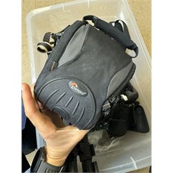 Collection of cameras and camera equipment, including Voigtlander Vitomatic I, Nikon Coolpix P340, Nikon Coolpix S9100, Olympus SP-510UZ, tripod, cases, etc