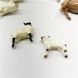 A group of Beswick figures, comprising two Charlie Wall Queen pigs, and a Charlie Wall Boy pig, two donkeys, sheep, and a lamb. 