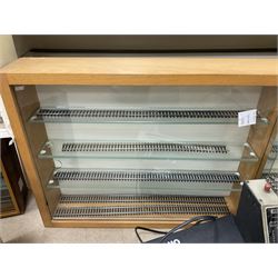 Six shelved cabinets for displaying ‘00’ gauge locomotives comprising plain plywood and white painted examples with track applied to various shelves, largest H63cm, W107cm, D27cm; Collection of tools for building model locomotives to include Weller PU-2D Soldering Pencil and Standard Tip Soldering Iron 20W/230V, Humbrol Modellers Airbrush, Power Supply Units and two wooden chests one of which housing a collection of tools including tweezers, scalping tools, wrenches etc 