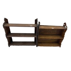 Close pair, early 20th century oak wall hanging shelves with pierced decoration