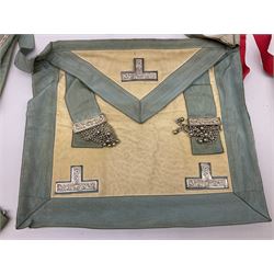 Two Masonic kid leather aprons, one with sash and cuffs, the other with sash, each marked 'Yorkshire North and East Ridings'; and three other unmarked Masonic aprons with sashes