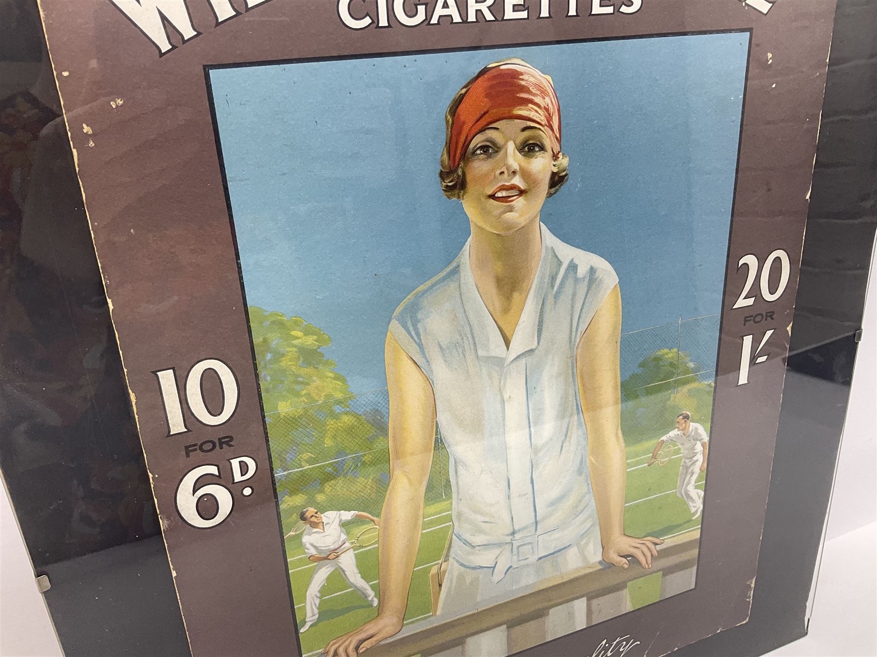Wills Gold Flake Cigarettes advertising board, framed depicting a lady at the tennis, advert H51cm, L38cm