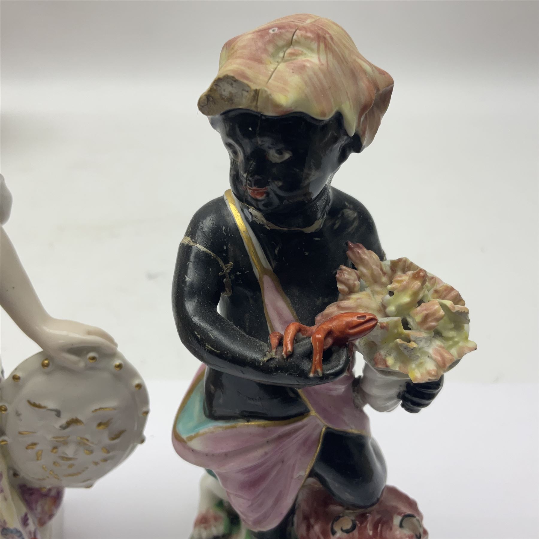 Group of 18th and 19th century ceramics for repair and restoration, to include an 18th century Derby figure emblematic of the Continent of Africa, pair of small 19th century Derby vases, painted with birds and floral spray, 19th century Derby slop bowl decorated in the 594 pattern with pink roses against gilt trellis, 19th century Derby figure of a recumbent deer, Serves style box, and two further figures