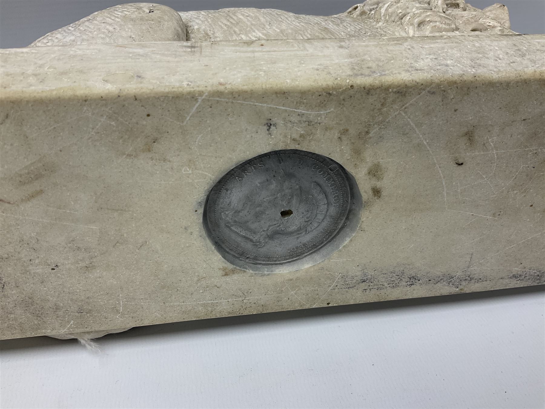 Two early 20th century reconstituted stone Grand Tour or Chatsworth House type lions after Antonio Canova, each modelled in recumbent pose upon a rectangular plinth, signed to plinth Dilettanti, each approximately L31cm