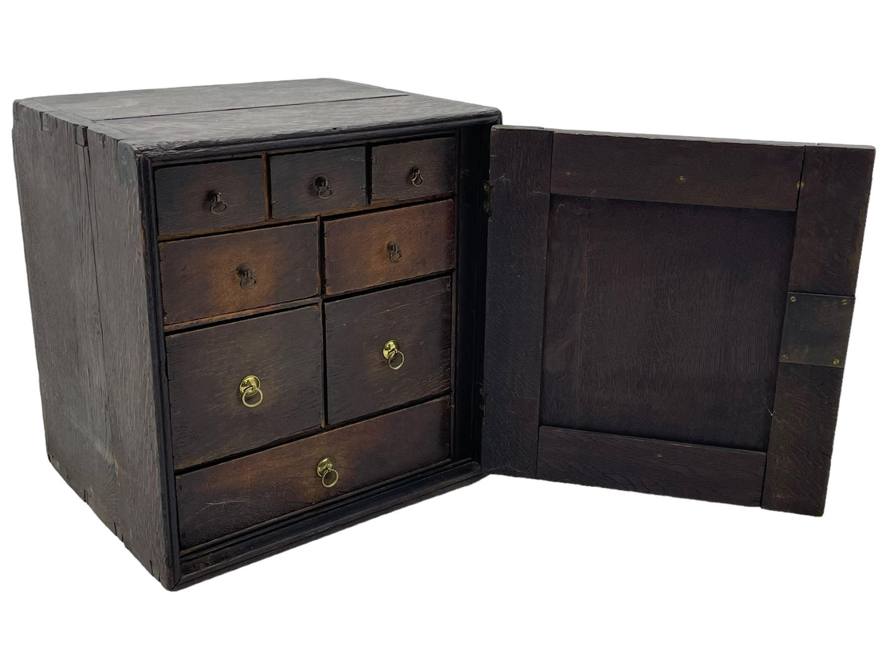 18th century oak spice cupboard, single panelled door enclosing eight drawers of various sizes, reed moulded front edges