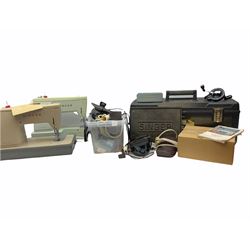 Two Singer sewing machines, model numbers 527 and 457, together with various Singer sewing machine parts, and a selection of sewing related accessories, to include threads, sewing needles, etc. 