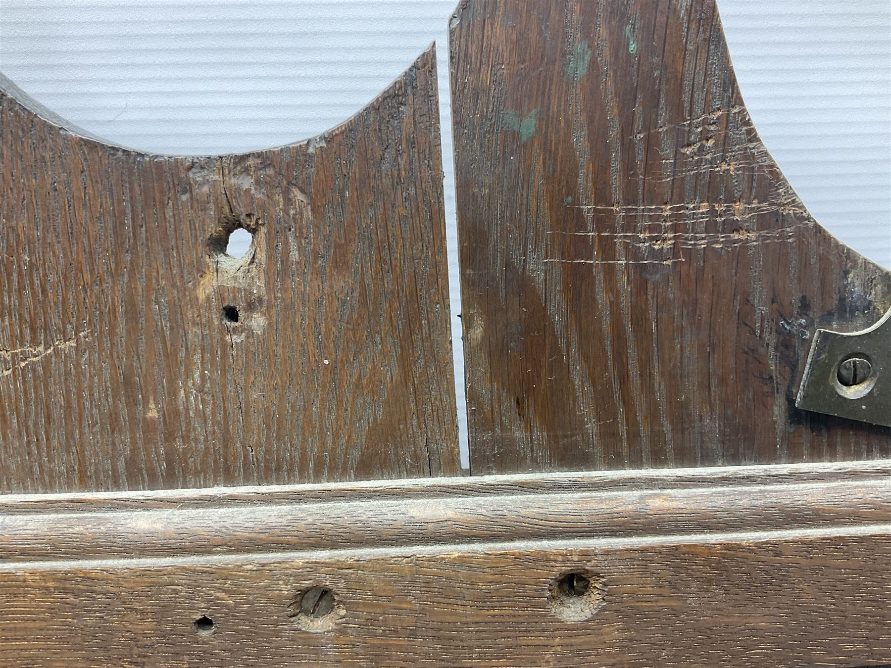 George III oak spoon rack and candle box, the rectangular backplate with shaped  pediment and two six aperture spoon racks, above a candlebox with hinged cover, with various brass spoons and a pair of brass candle snuffers, H56.5cm, W35cm, D14cm 