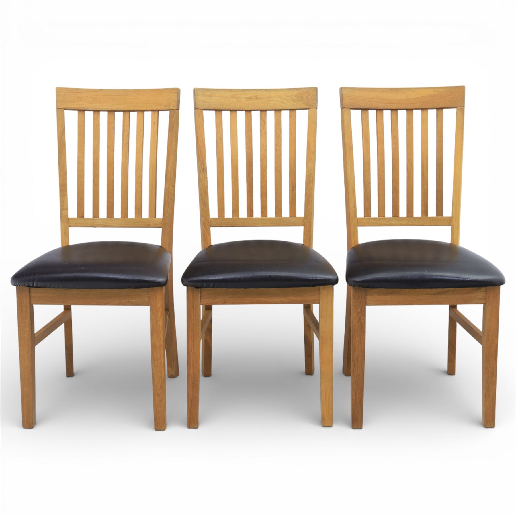 Solid light oak extending dining table with single leaf, and set of six chairs