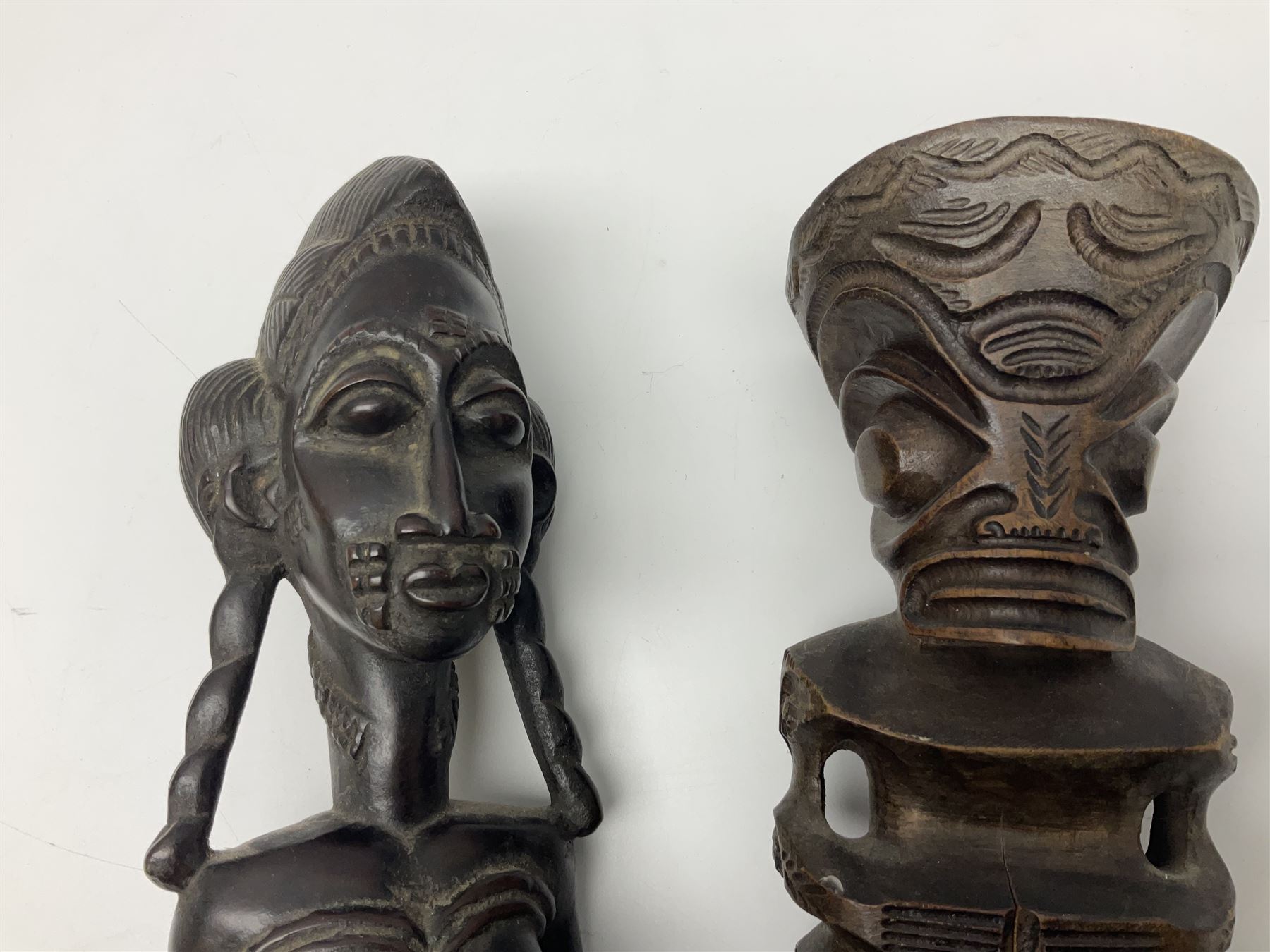 Carved african figures, together with a polynesian figure, largest H38cm
