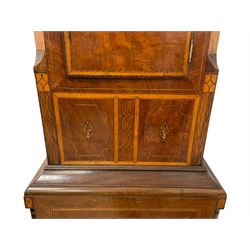 John Stonehouse of Leeds - mahogany 8-day longcase clock with a painted oval dial c1830, hood with a swans necked pediment and profuse contrasting inlay to both the hood and case, oval hood door with flanking pilasters and Corinthian capitals, conforming case with canted corners and short triple spire door, broad plinth with matching inlay and canted corners on shallow base, dial depicting masonic regalia, symbols, and pictorial depictions of the humanities, faith, hope, charity and righteousness, black chapter with white roman Arabic’s, date recorder and matching “crown” hands, dial pinned to a rack striking movement with a recoil anchor escapement, striking the hours on a coiled underslung gong. With weights and gridiron pendulum. 
This clock case is of large, impressive dimensions and was almost certainly commissioned for a large masonic lodge in Leeds, a rare and unique example.